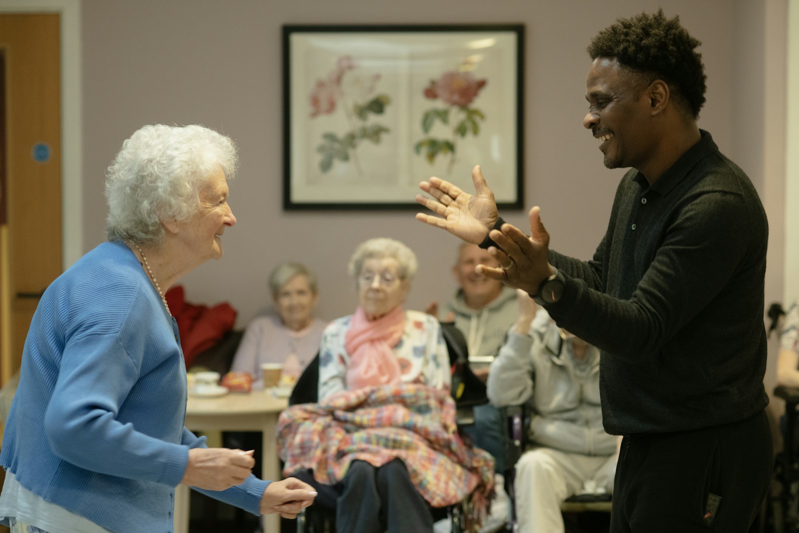 Caregiver sharing a joyful moment with an elderly client