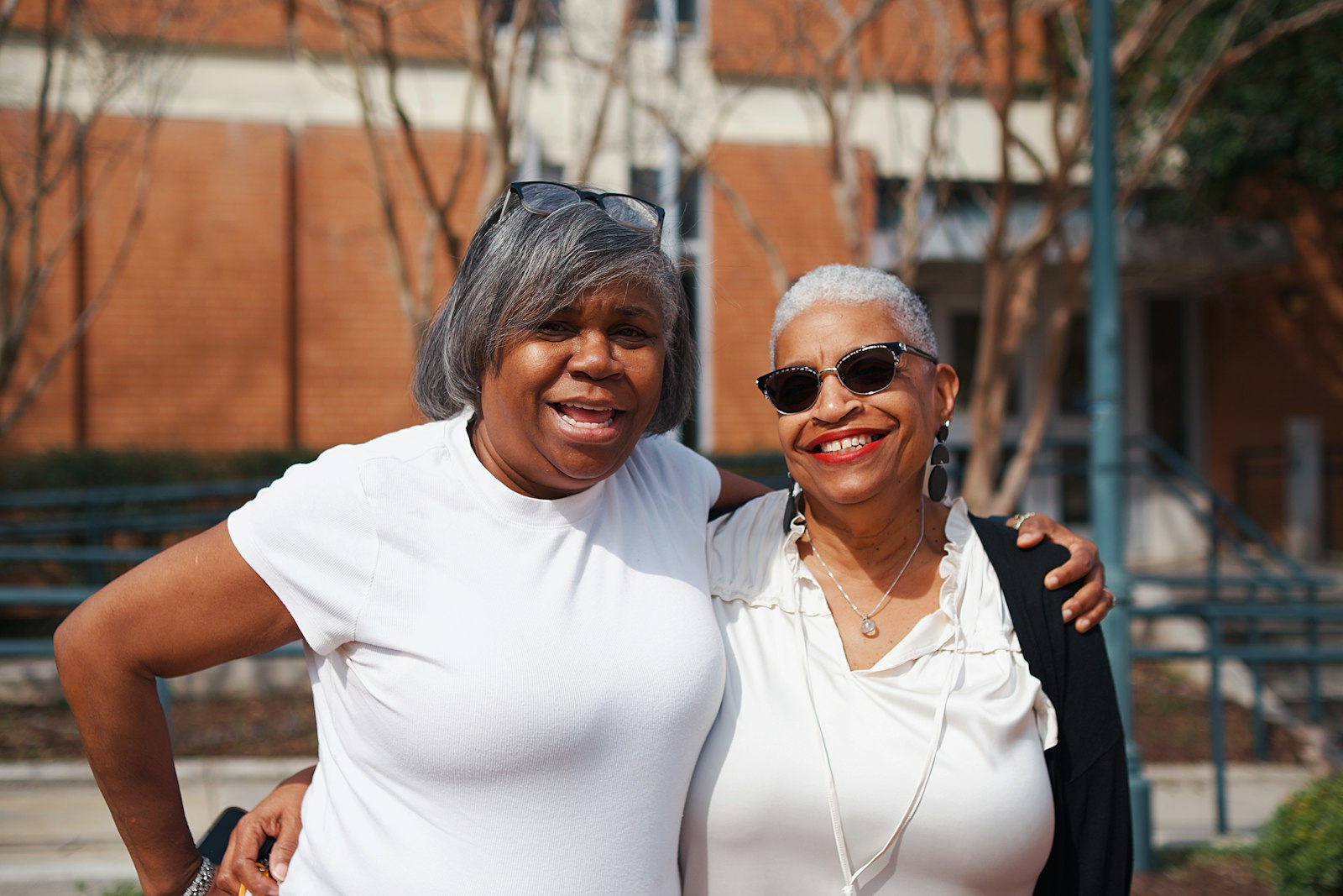 Two joyful clients embracing outdoors
